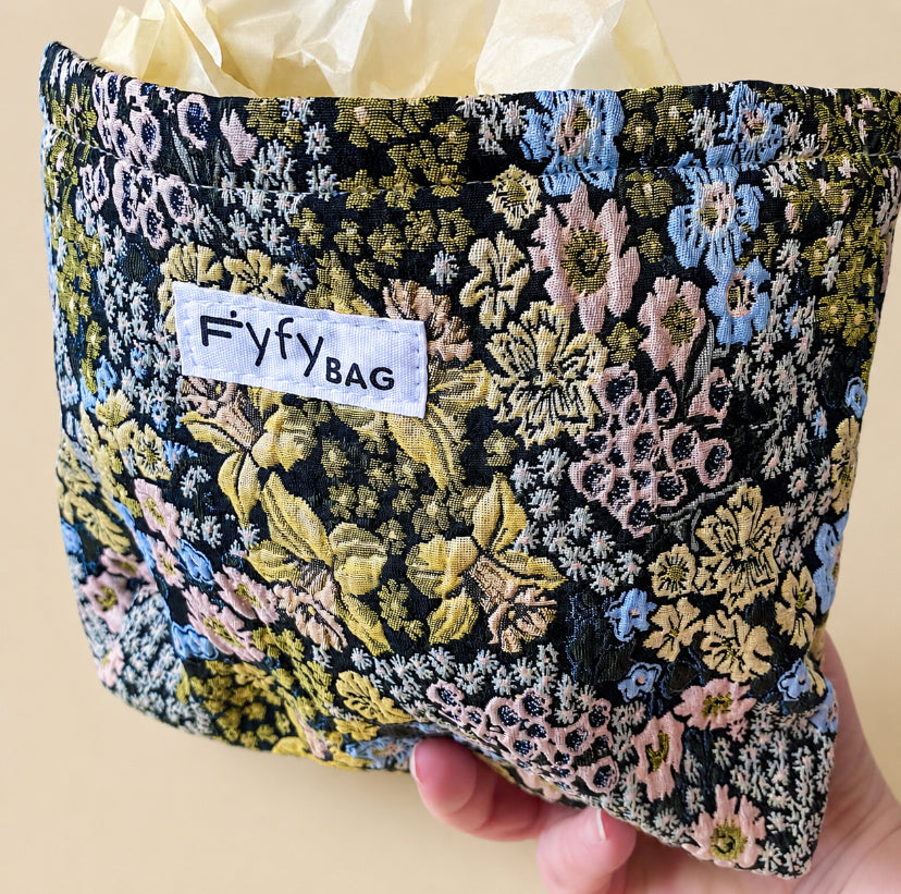 beautiful woven floral tapestry pouch with cream lining, concealed zip- finish and gusseted base. English garden at twilight themed pattern with daffodils, foxgloves, blue pink and yellow flowers. Perfect for cosmetics, stationery and everyday essentials.