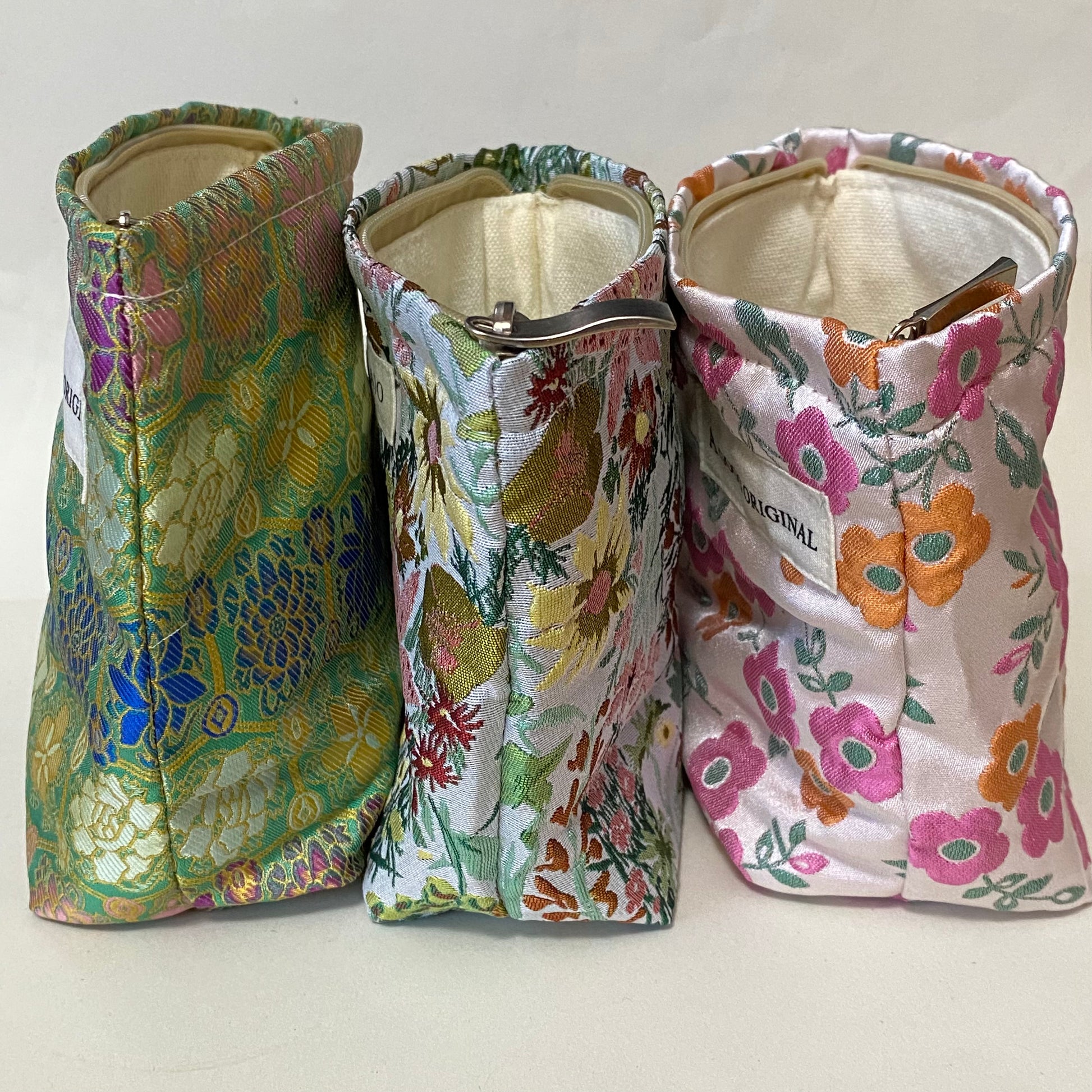 premium woven brocade cosmetic pouch in jade green with intricate mosaic inspired pattern in blue, purple, antique gold and cream. Fully lined with concealed zip. UK letterbox gifts shop. Small ornate fabric make up bag. 