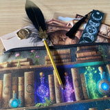 celestial moon phase bookmark with black tassel and black feather ballpoint pen on a canvas potions bag